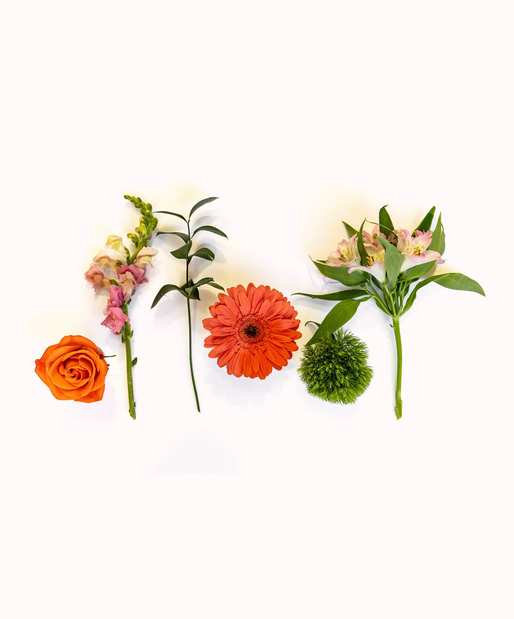 Vibrant floral arrangement featuring orange roses, gerbera daisies, and greenery elements.